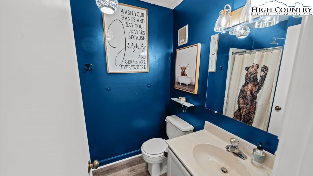 301 Pinnacle Inn Road, Unit 1114 Beech Mountain, NC 28604 - Photo 13 of 16 a bathroom with a toilet sink and mirror