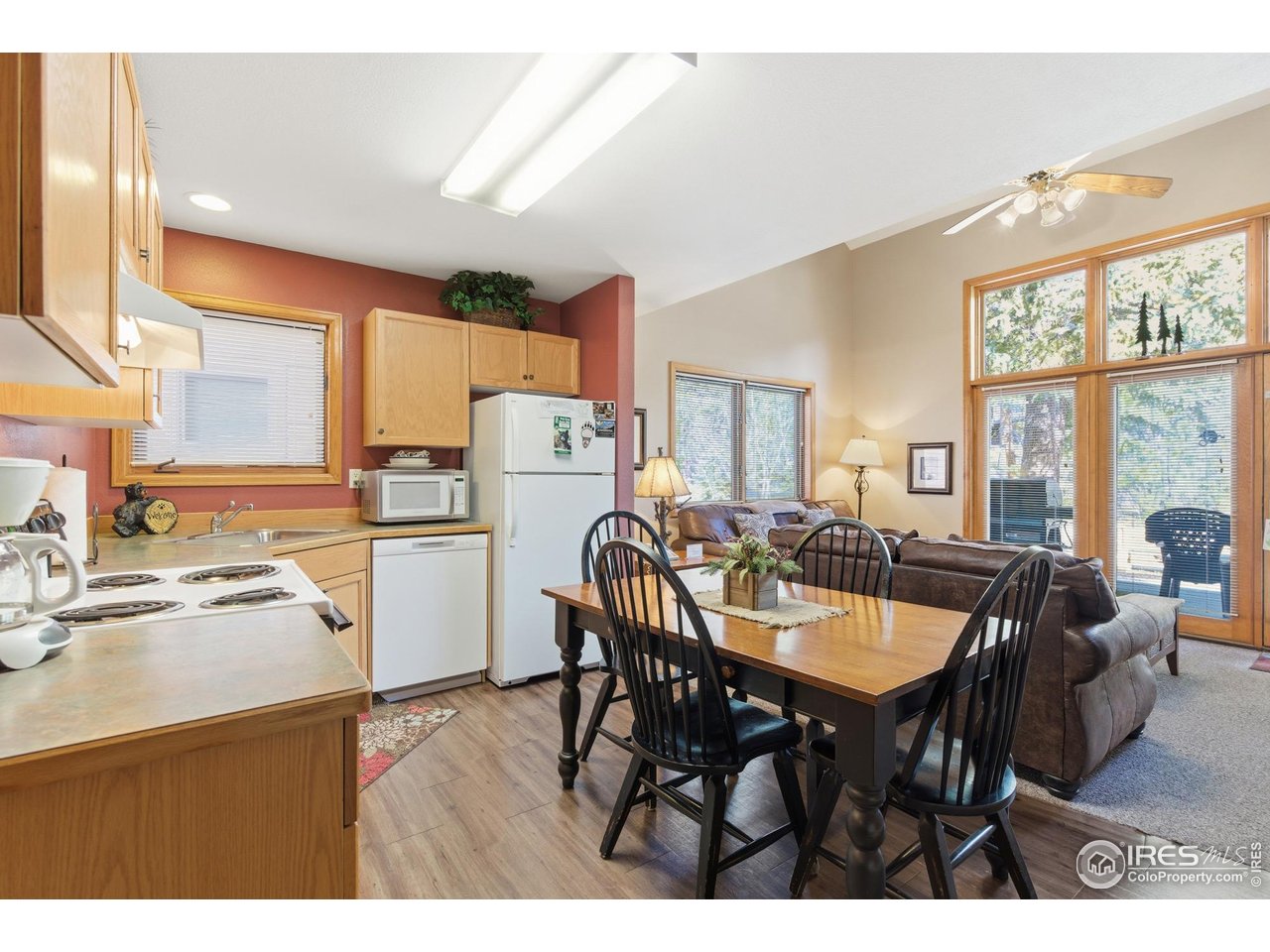 2120 Fall River Road, Unit 2 Estes Park, CO 80517 - Photo 12 of 28 a open dining room with stainless steel appliances kitchen island granite countertop a table chairs and a refrigerator