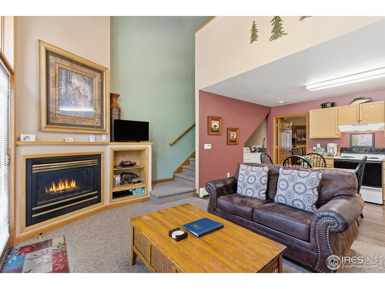 2120 Fall River Road, Unit 2 Estes Park, CO 80517 - Photo 5 of 28 a living room with furniture a flat screen tv and a fireplace