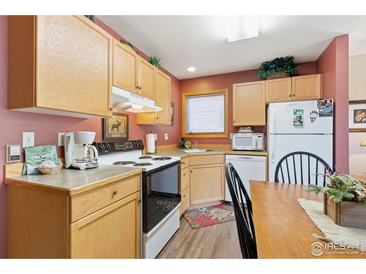 2120 Fall River Road, Unit 2 Estes Park, CO 80517 - Photo 10 of 28 a open kitchen with a sink a stove a dining table and chairs