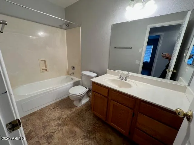 a bathroom with a sink a toilet and a large mirror
