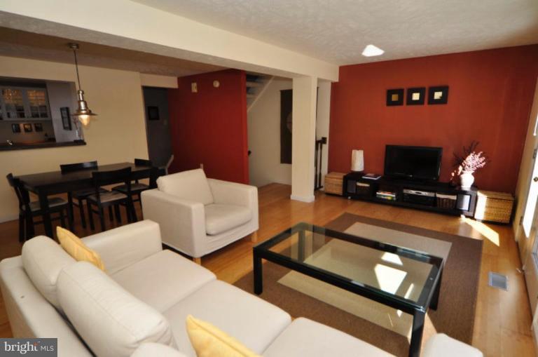 1491 Autumn Ridge Circle Reston, VA 20194 - Photo 3 of 20 a living room with furniture a rug and a flat screen tv