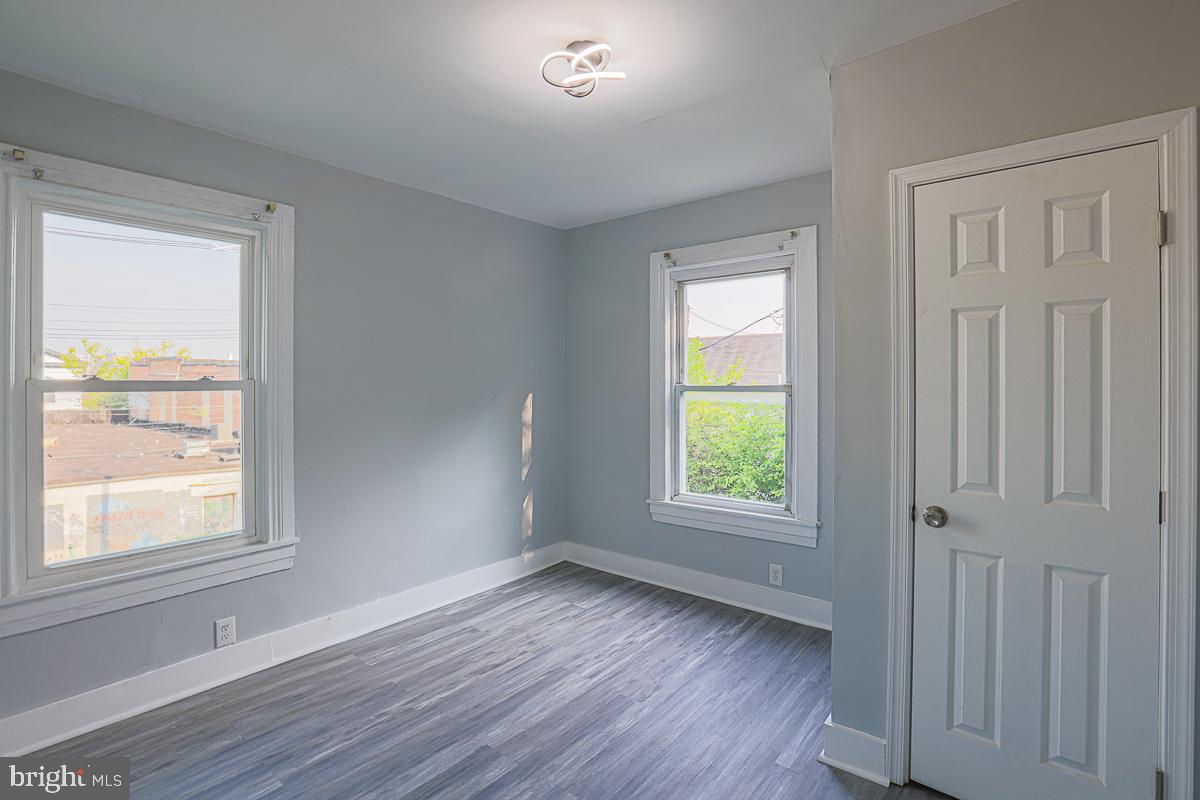 604 East 31st Street Baltimore, MD 21218 - Photo 34 of 50 a view of an empty room with wooden floor and a window
