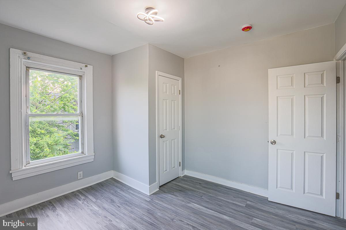 604 East 31st Street Baltimore, MD 21218 - Photo 35 of 50 a view of an empty room with wooden floor and a window