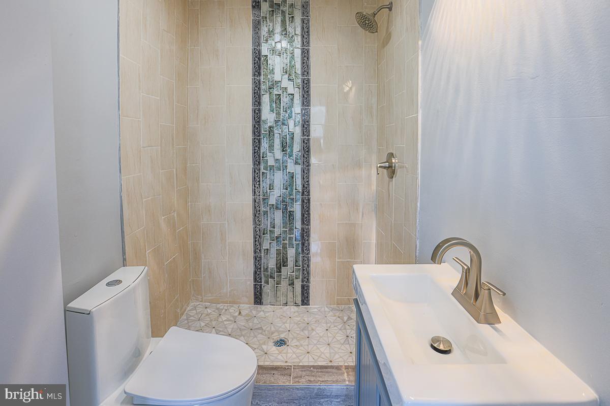 604 East 31st Street Baltimore, MD 21218 - Photo 44 of 50 a bathroom with a sink and a mirror