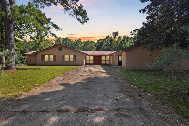 a view of house with yard and green space