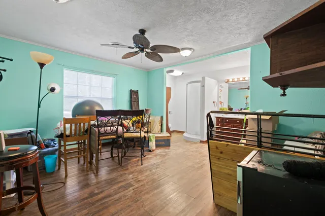 a dining room with furniture and wooden floor