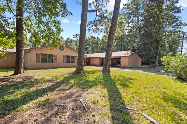 a house view with swimming pool in front of it