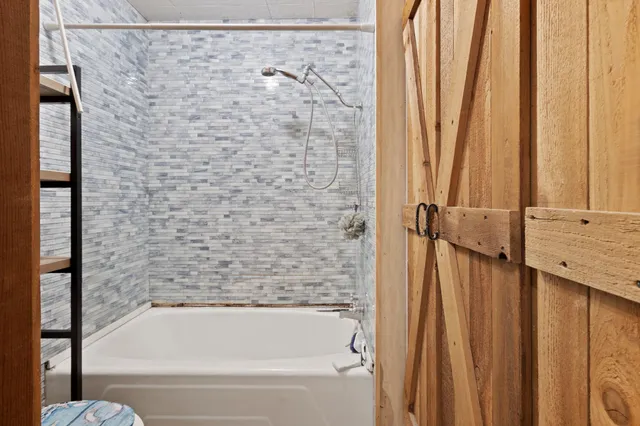 a bathroom with bathtub and shower