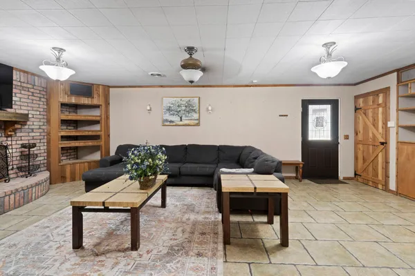 a living room with furniture a lamp and a rug
