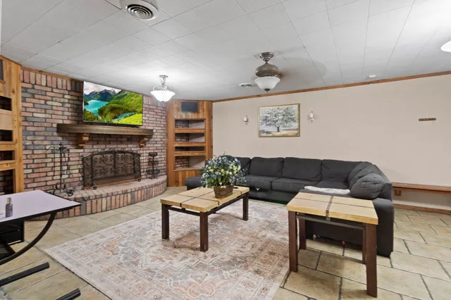 a living room with furniture and a fireplace