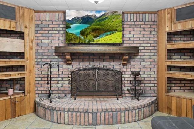 a room with fireplace furniture and a book shelf