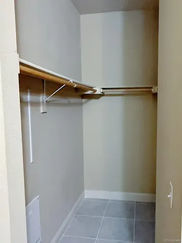 a spacious bathroom with a granite countertop sink a toilet and a mirror