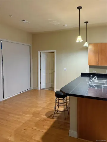 a view of a room with a table and chairs