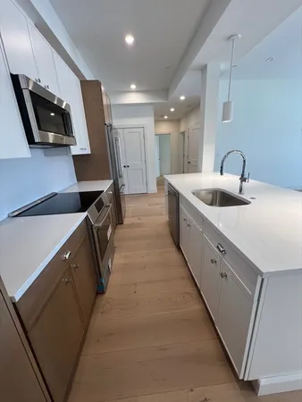 a kitchen with sink stove and cabinets