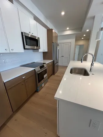 a kitchen with stainless steel appliances granite countertop a sink and a microwave