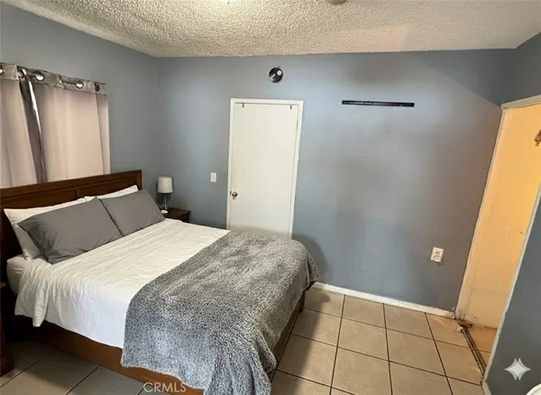 a bedroom with a bed and a large mirror