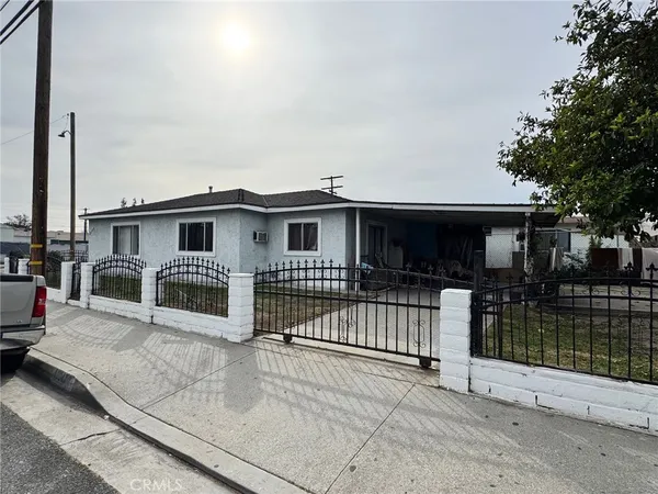 a view of a house with a wooden fence