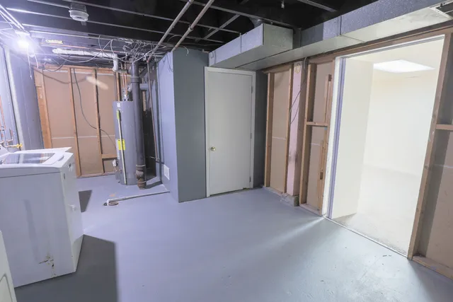 a view of a house with a large tree and wooden fence