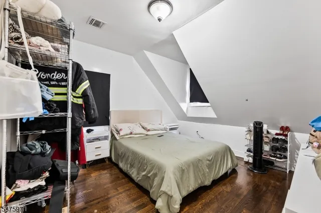 a bed room with a bed and a book shelf