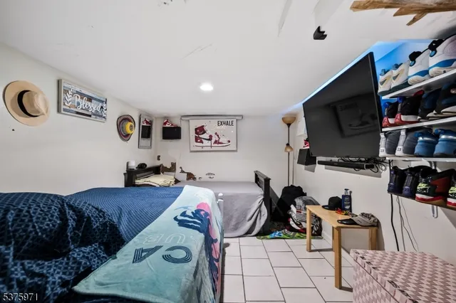 a bed room with a bed a television and a couch