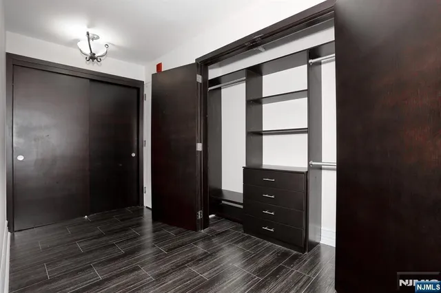 a view of a balcony with wooden floor and fence