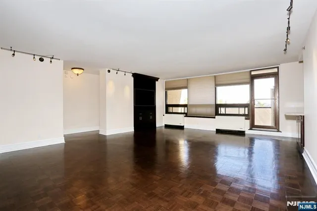 a view of a kitchen with a sink and a refrigerator