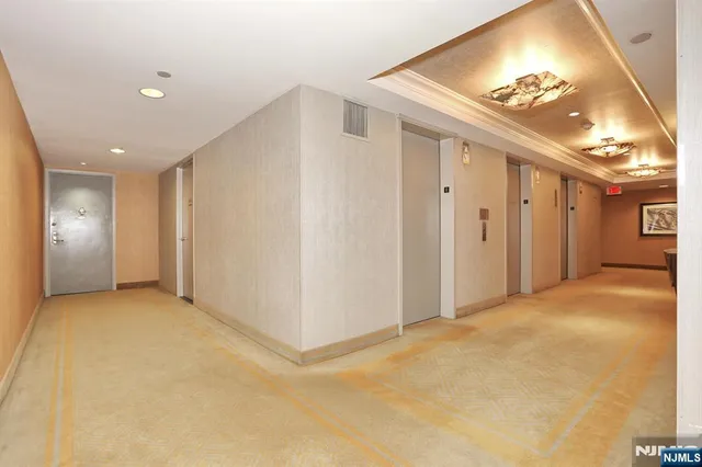 a lobby with furniture and a floor to ceiling window