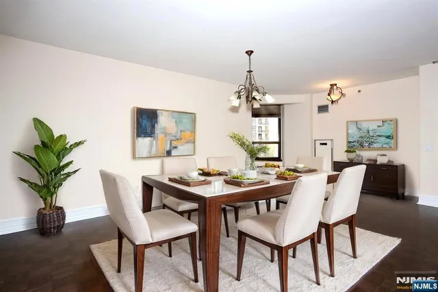 a view of a dining room with furniture and chandelier