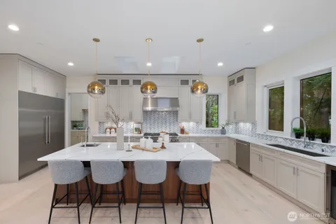 a large kitchen with a table and chairs