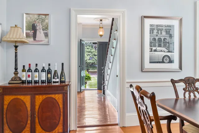 a dining room with furniture and wooden floor