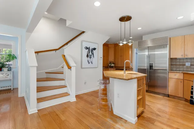 a kitchen with kitchen island granite countertop a sink and a stove