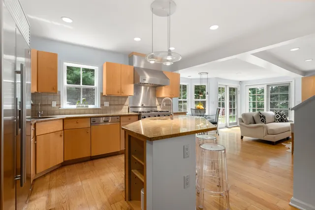a kitchen with a sink stove and a refrigerator