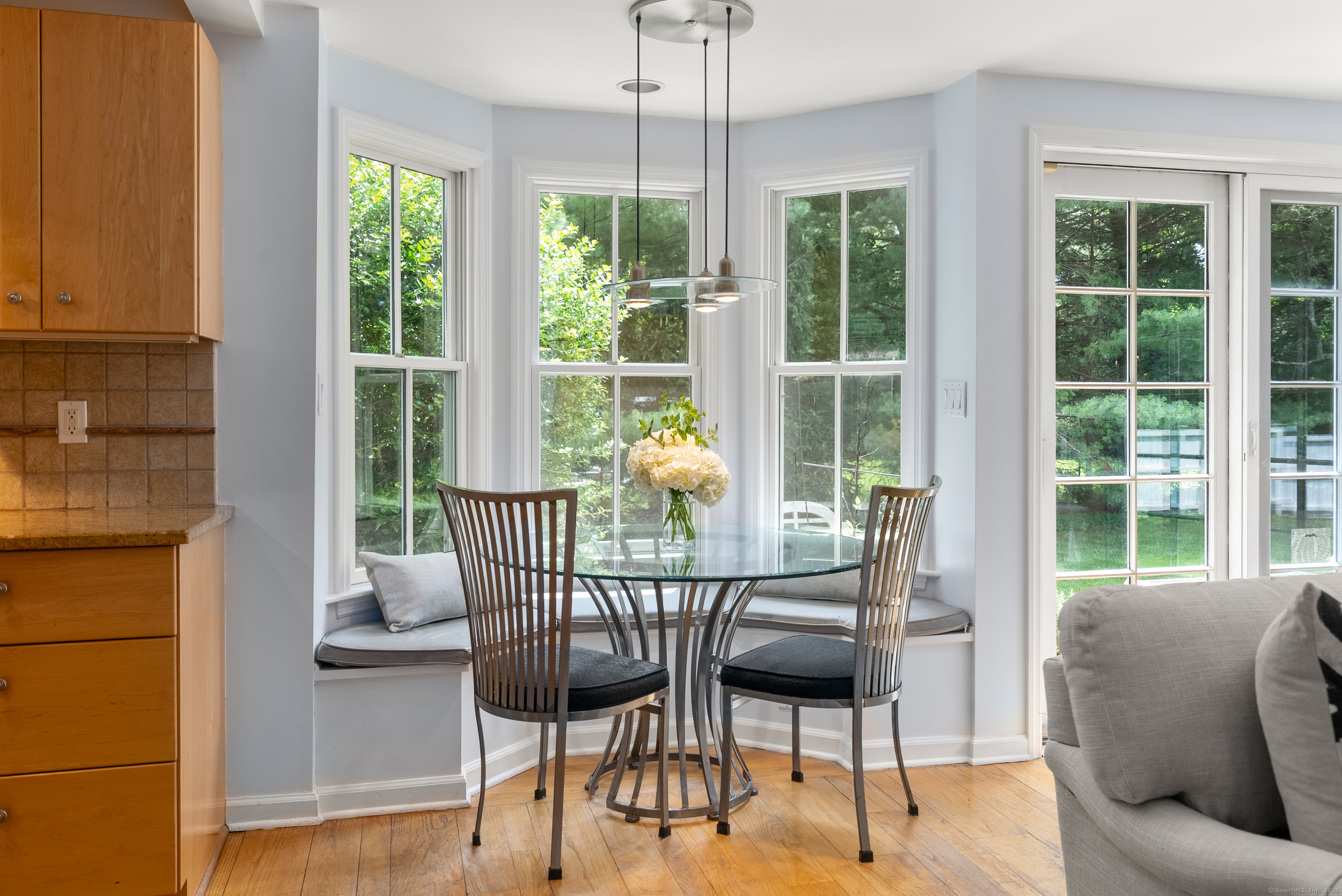 18 Bridge Street Westport, CT 06880 - Photo 20 of 36 a dining room with furniture a chandelier and glass door