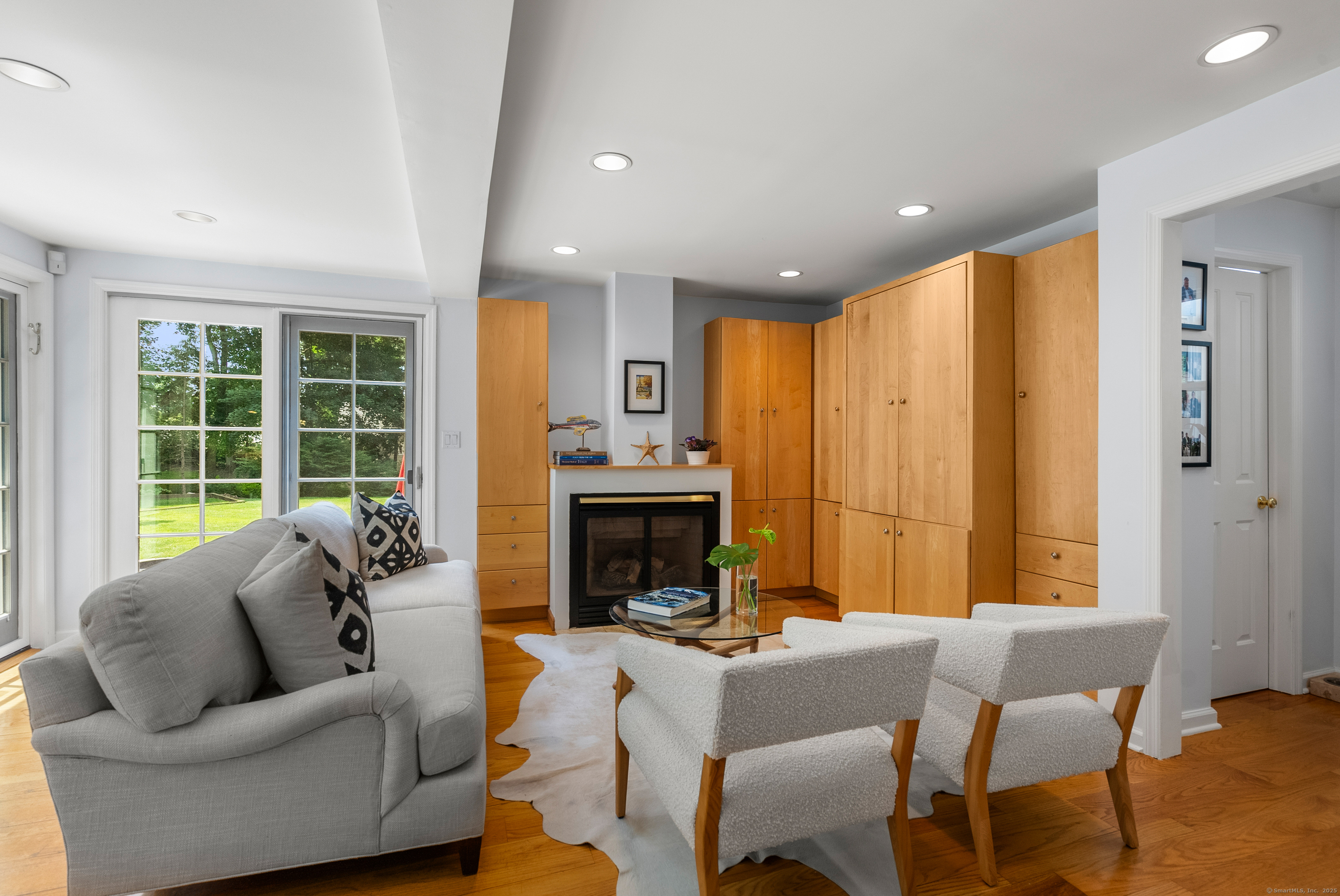 18 Bridge Street Westport, CT 06880 - Photo 22 of 36 a living room with furniture a fireplace and a large window