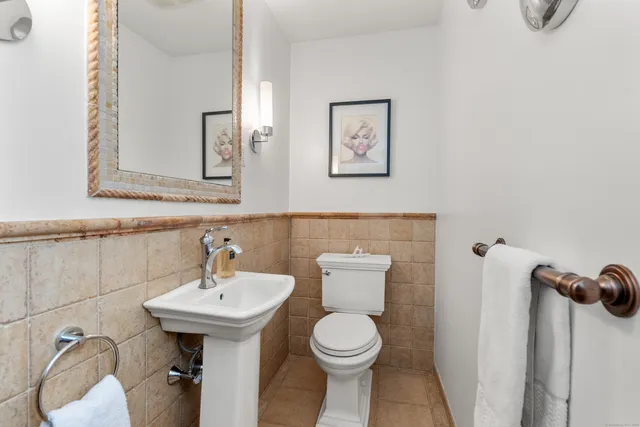 a bathroom with a sink mirror and toilet