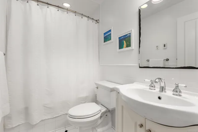 a bathroom with a sink toilet and a mirror