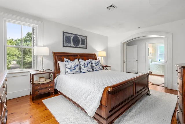 a bed sitting in a bedroom next to a window