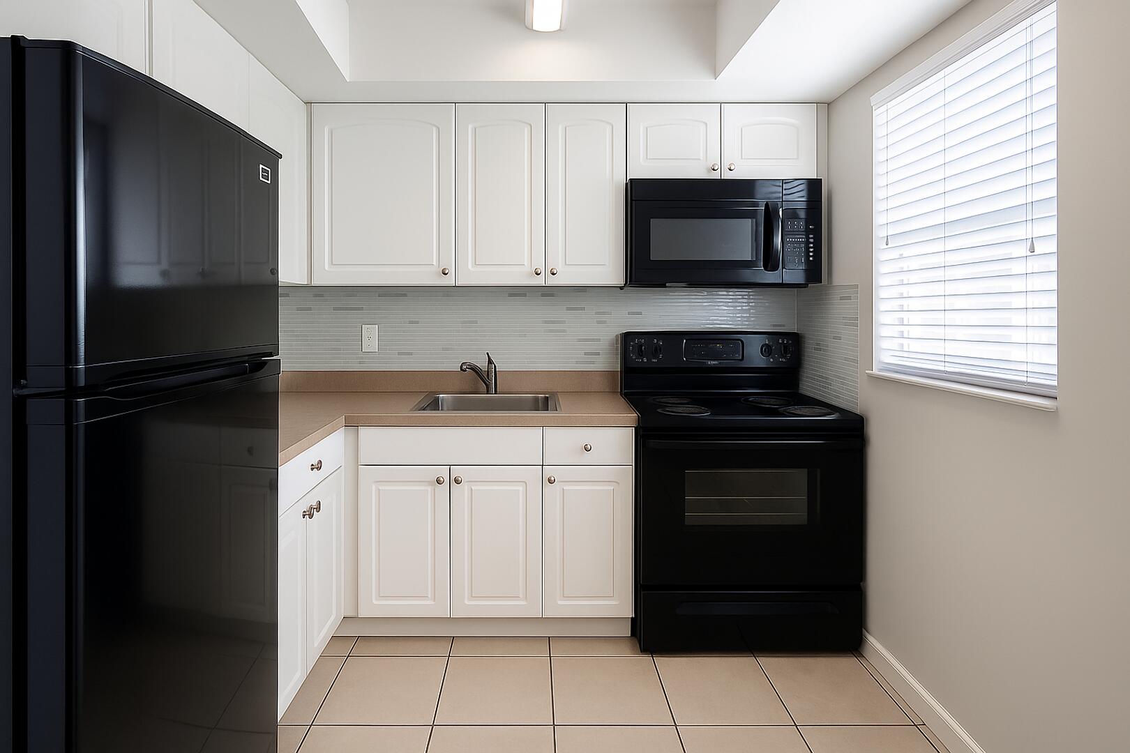 665 Glouchester Street, Unit 14 Boca Raton, FL 33487 - Photo 1 of 6 a kitchen with a refrigerator stove and microwave