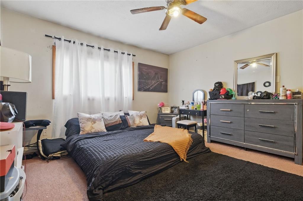 43 Orchard Street McKees Rocks, PA 15136 - Photo 16 of 18 a bedroom with a bed and a chandelier