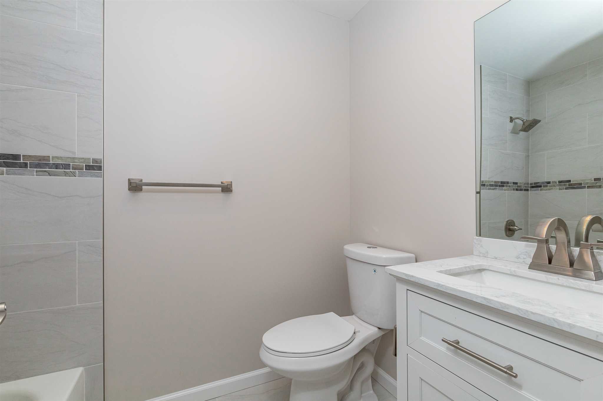 9 Manor Way Poughkeepsie, NY 12603 - Photo 11 of 23 a bathroom with a toilet a sink and vanity