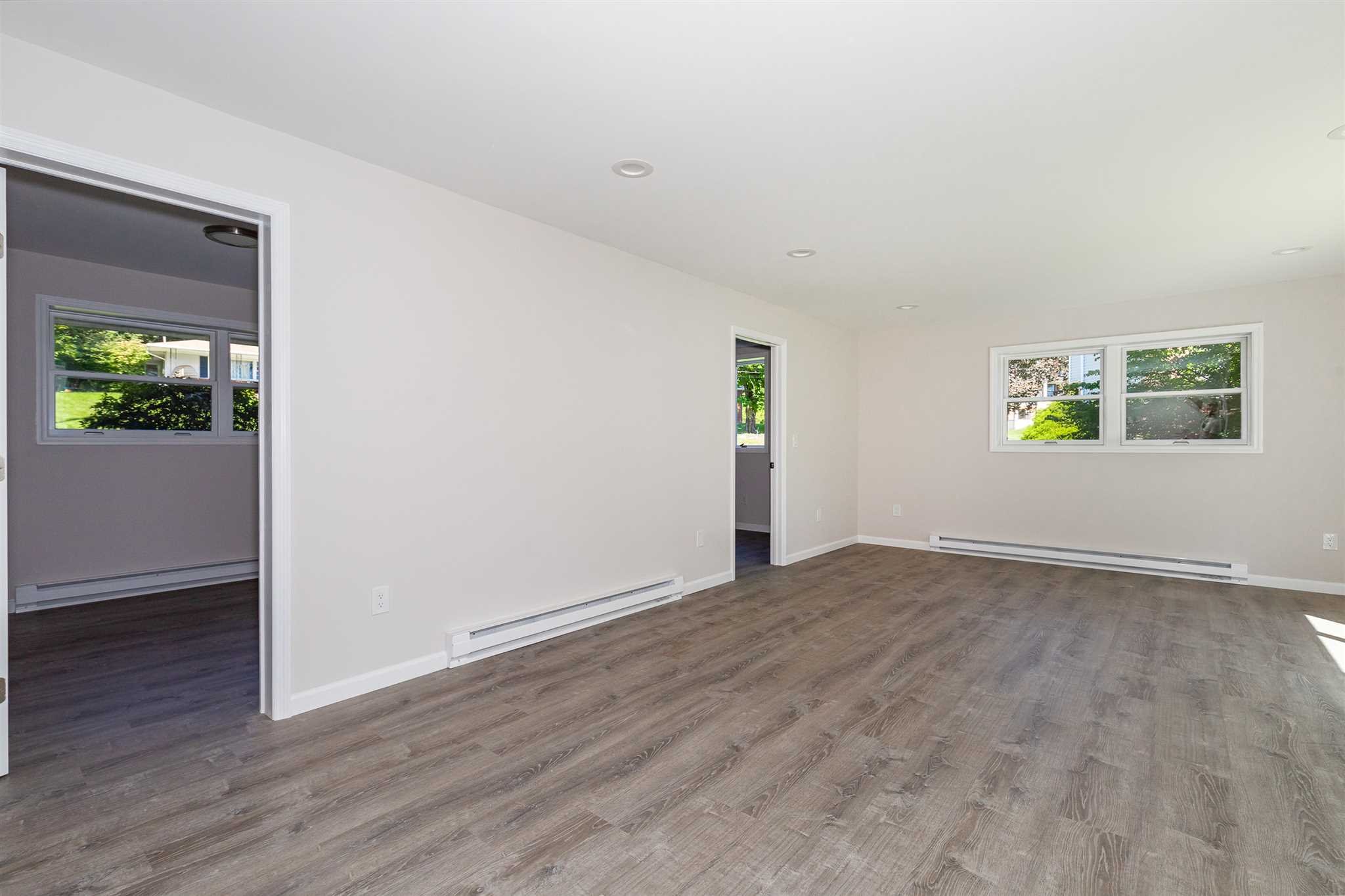 9 Manor Way Poughkeepsie, NY 12603 - Photo 12 of 23 an empty room with wooden floor and windows