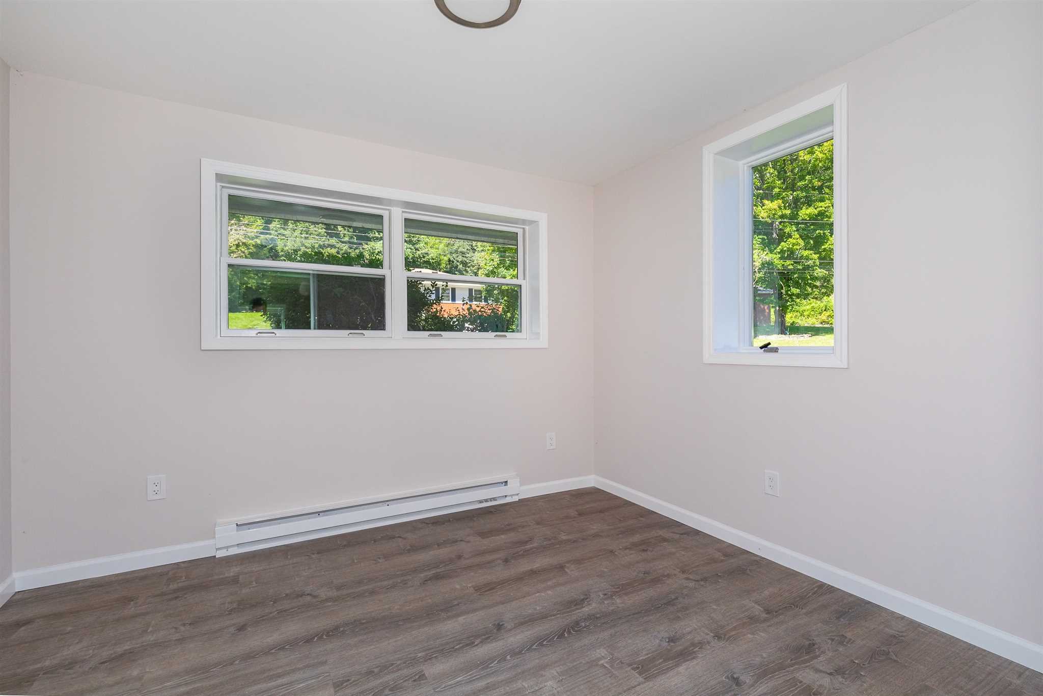 9 Manor Way Poughkeepsie, NY 12603 - Photo 14 of 23 an empty room with wooden floor and windows