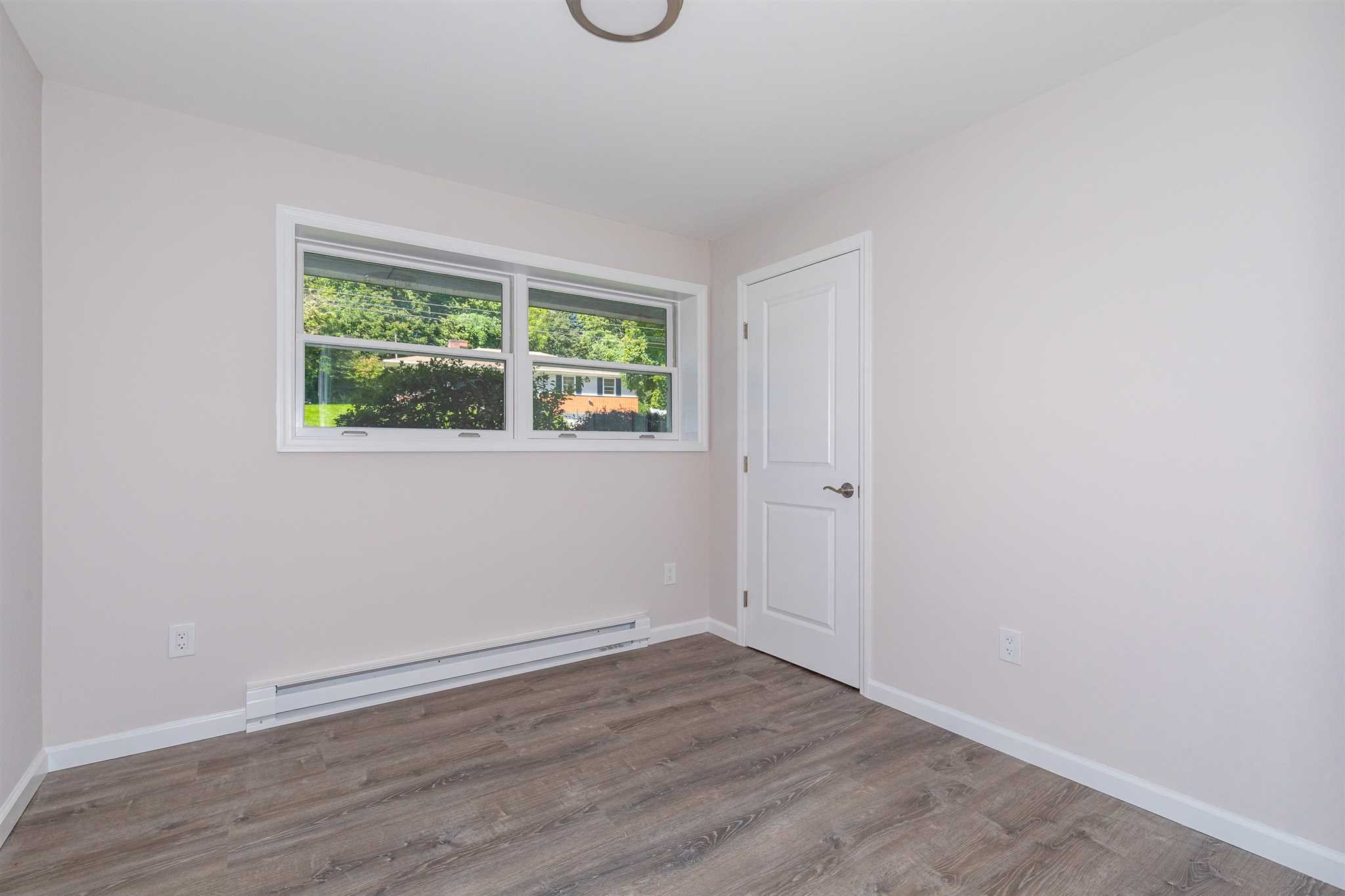 9 Manor Way Poughkeepsie, NY 12603 - Photo 15 of 23 a view of an empty room with wooden floor and a window