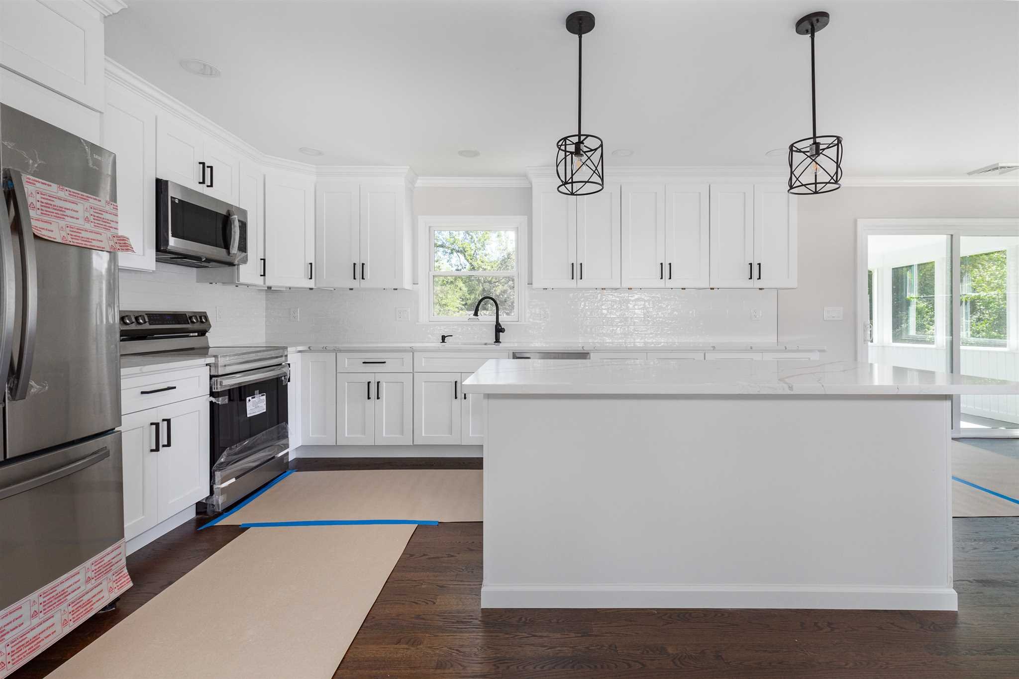 9 Manor Way Poughkeepsie, NY 12603 - Photo 4 of 23 a kitchen with stainless steel appliances granite countertop a sink a stove a refrigerator cabinets and a window