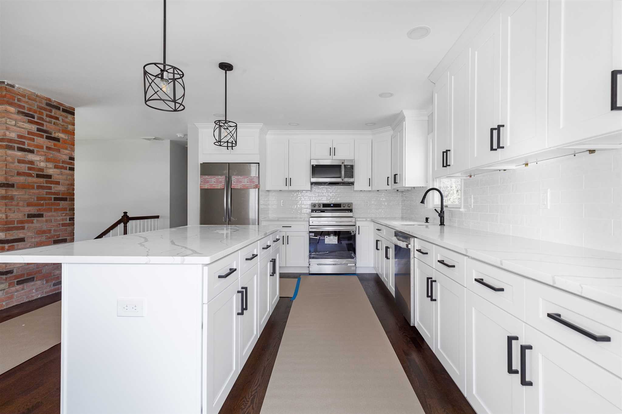 9 Manor Way Poughkeepsie, NY 12603 - Photo 5 of 23 a kitchen with kitchen island granite countertop a sink a counter top space stainless steel appliances and cabinets