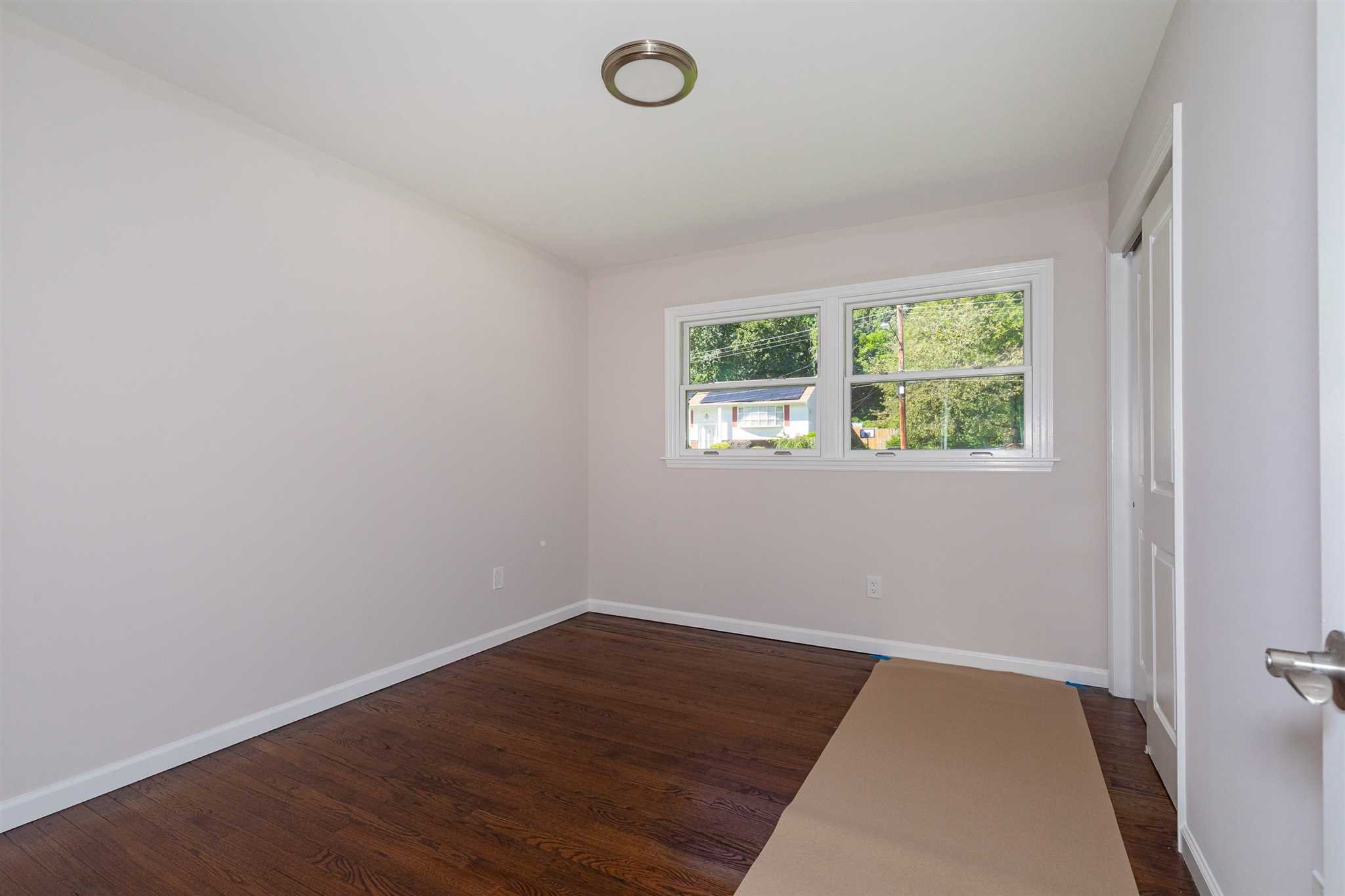 9 Manor Way Poughkeepsie, NY 12603 - Photo 10 of 23 an empty room with wooden floor and windows