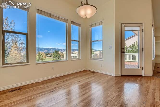 13968 Windy Oaks Road Colorado Springs, CO 80921 - Photo 15 of 34 a view of an empty room with wooden floor and a window