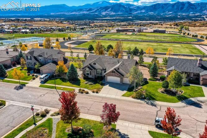 13968 Windy Oaks Road Colorado Springs, CO 80921 - Photo 2 of 34 an aerial view of a house with a yard and lake view