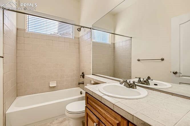 13968 Windy Oaks Road Colorado Springs, CO 80921 - Photo 22 of 34 a bathroom with a sink and a mirror